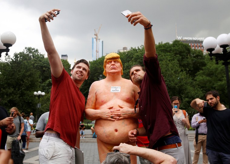 Image: People pose for selfies with a naked statue of U.S. Republican presidential nominee Donald Trump that was left in Union Square Park in New York