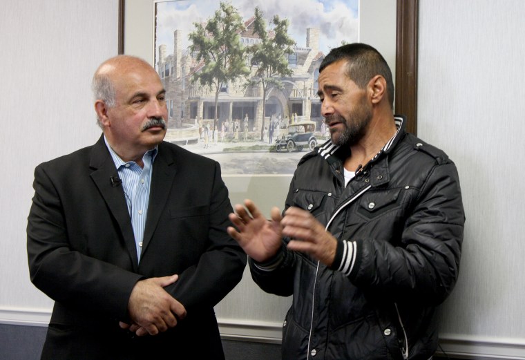 Fariz Turkmani, a Kansas City businessman, interprets for Syrian refugee Ahmad al-Abboud.