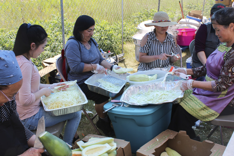 Hmong women cooking and cutting vegetables at a Hmong festival in St. Paul, Minnesota