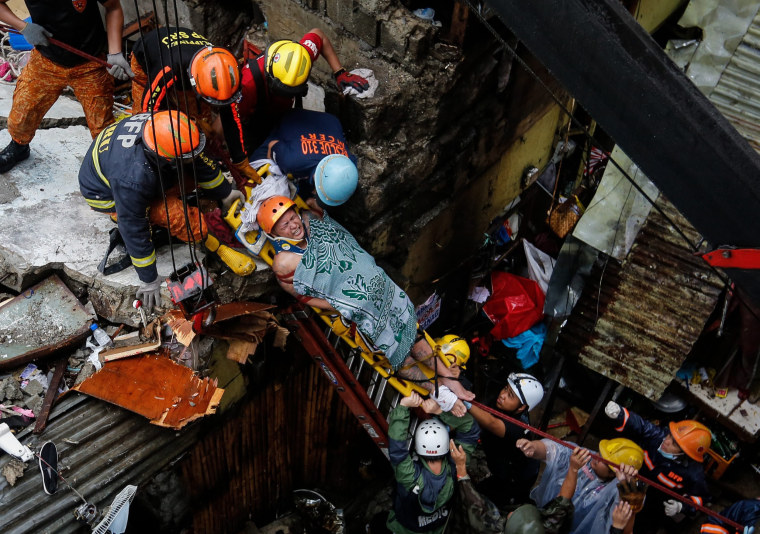 Image: Concrete wall collapses in Manila damaging houses and killing two