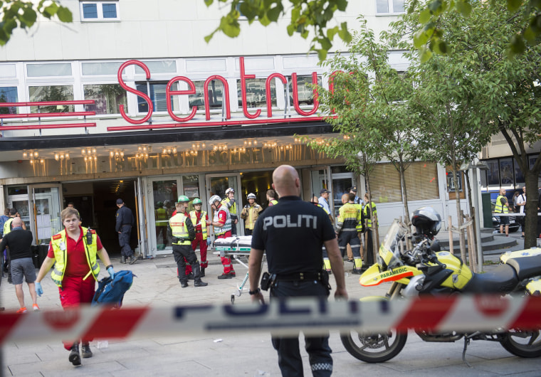 Image: Police and emergency personnel gather at the entrance of a concert venue, Setrum Scene