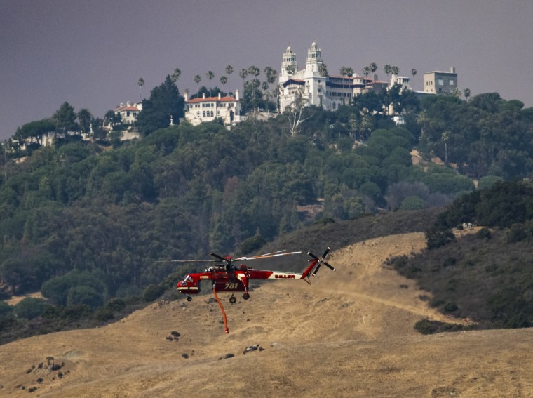 Image: A helicopter flies past Hearst Castle