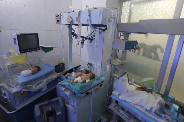 Image: Babies are seen inside a nursery at a children's hospital that was partially damaged from recent airstrikes, in a rebel held area of Aleppo