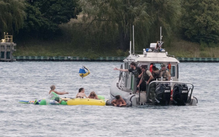 A Customs and Border Protection boat helps floaters during Float Down on the St. Clair River in Port Huron, Mich., Sunday, Aug. 21, 2016.