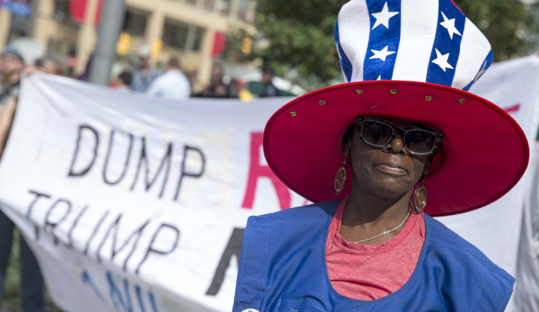 Image: A protester with the End Poverty Now rally marches through downtown Cleveland, the site of Republican National Convention.