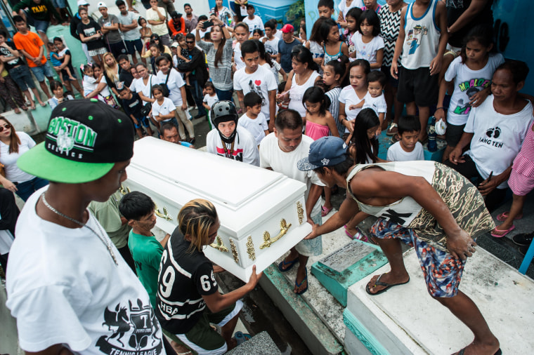 Image: Relatives mourn as the casket of an alleged drug peddler and victim of an extrajudicial killing is laid to rest Monday in Manila, Philippines.