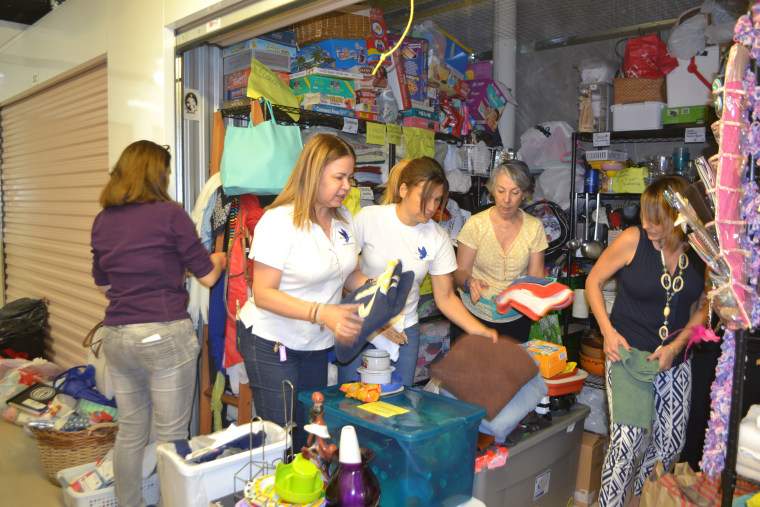 Patricia Andrade (left) and other volunteers organizing one of the storage spaces