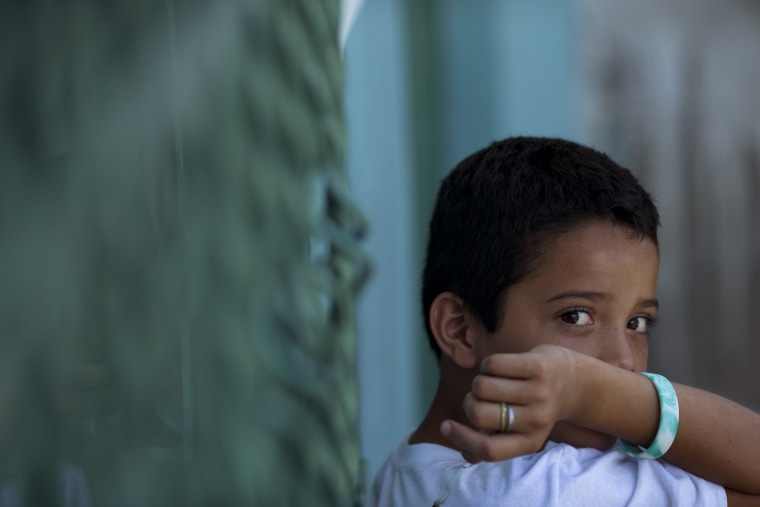 Edwin Lemus, 10, from El Salvador, sits in the men's section of a shelter providing temporary refuge for migrants.