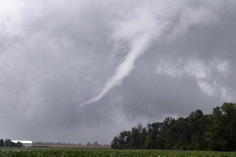 A funnel cloud near Van Buren, Indiana moves east before breaking up as storms move through Grant County. At least two tornadoes struck cities in tearing the roof off apartment buildings, sending air conditioners falling onto parked cars and cutting power to thousands of people.