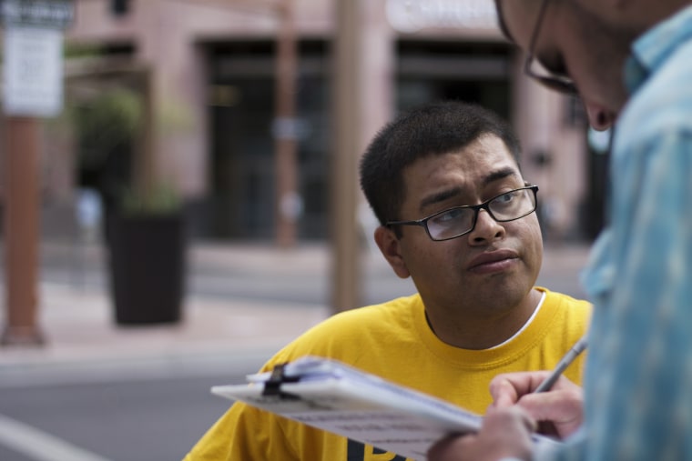 Image: Jose Barboza, a Promise Arizona volunteer, registers voters in Phoenix