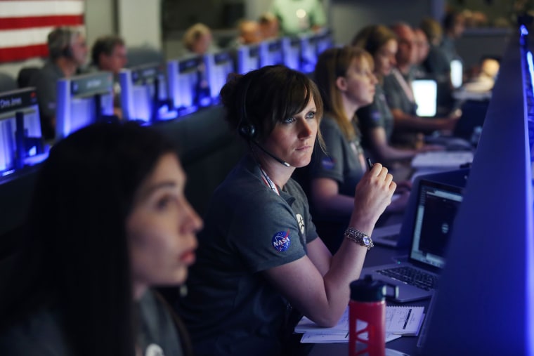 Image: Staff members watch on before the solar-powered Juno spacecraft went into orbit around Jupiter