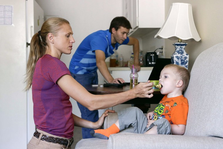 Image: Russian Olympian couple Yuliya and Vitaly Stepanovs with their son after an interview with Reuters
