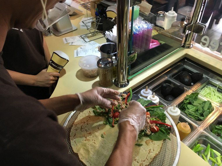 An employee assembles a crepe at one of several T-Swirl crepe locations.