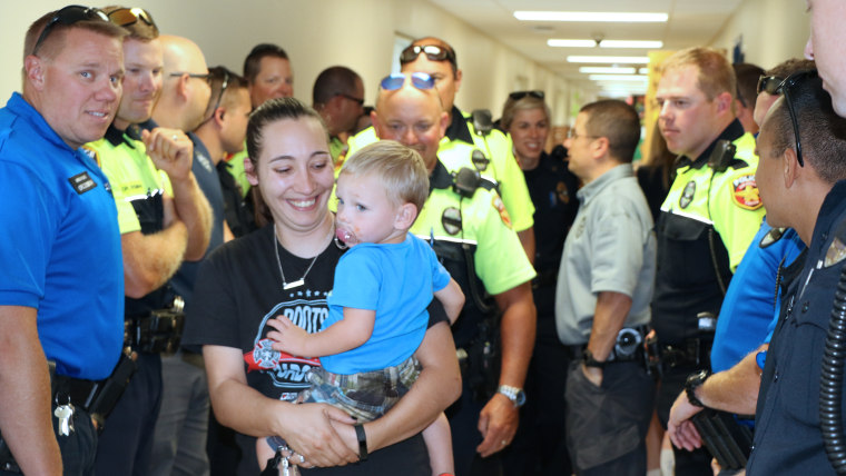 police officers surprising the children of an officer who died by walking them to the first day of school