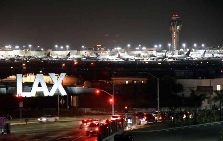 Image: Traffic is seen near the LAX sign in Los Angeles