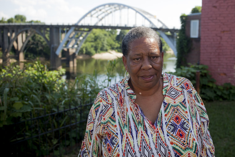 Joanne Bland stands in front of the Edmund Pettus Bridge in Selma. Bland was the youngest marcher on Bloody Sunday at just 11 years old. She now revisits the bridge when she gives historical tours of Selma. (Jeffrey Pierre/News21)