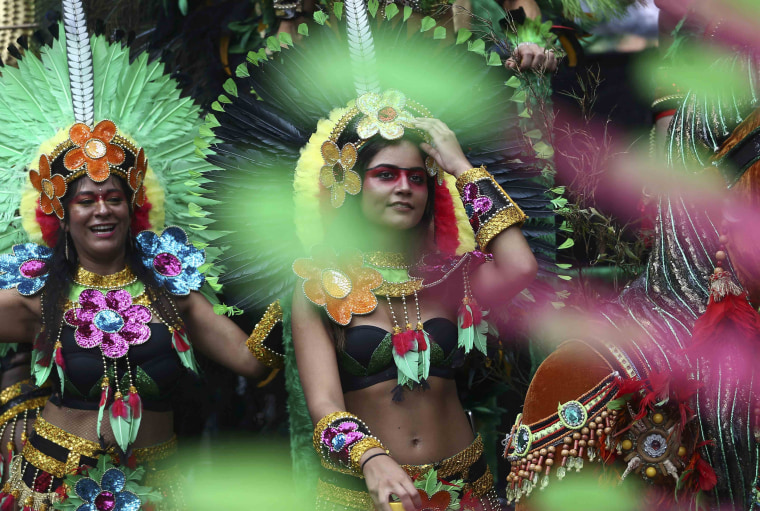Image: Performers participate in the parade at the Notting Hill Carnival in London