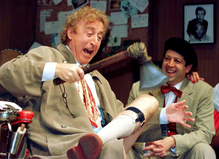 Image: American actor Gene Wilder (L) performs alongside compatriot Rolf Saxon, during the rehearsal of a scene from Neil Simon's