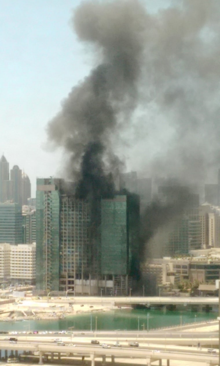 Image: Smoke rises from a blaze in a high-rise building under construction in Abu Dhabi, United Arab Emirates.