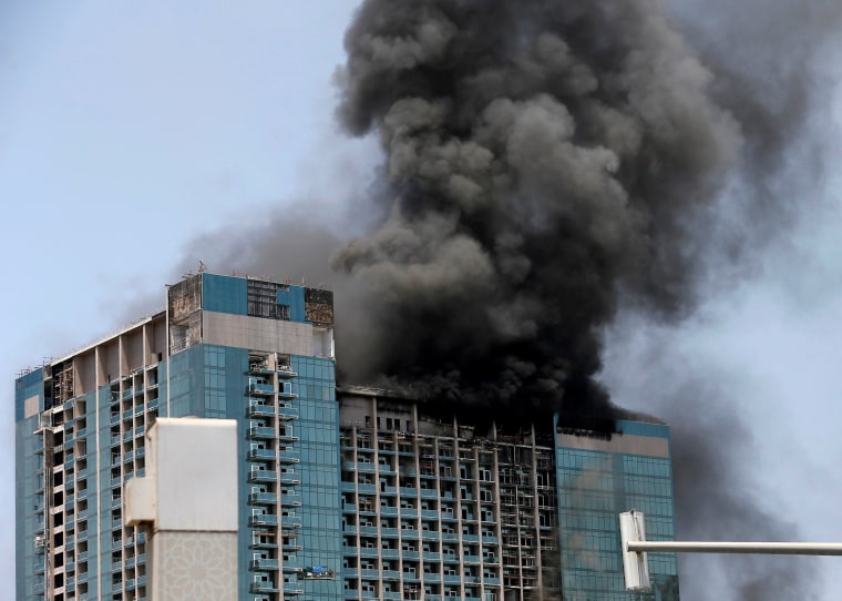 Image: Smoke rises after a fire broke out in a building at Al Maryah Island in Abu Dhabi