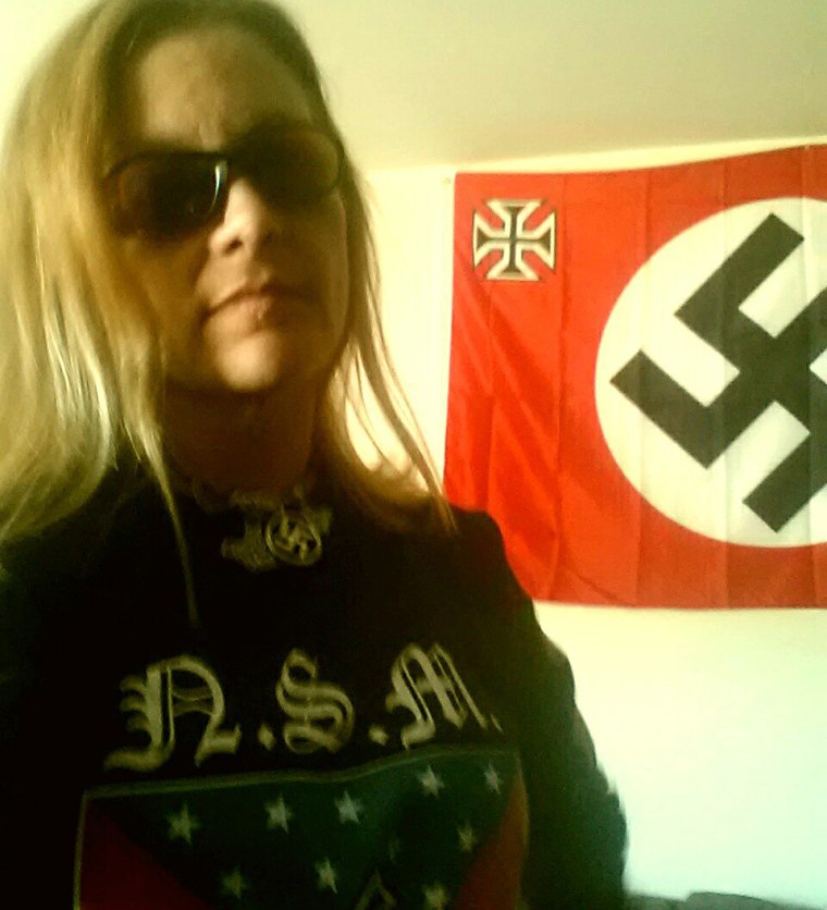Rebecca Barnette stands in front of a flag with a swastika in her profile picture on the Russian social media site VK.com.