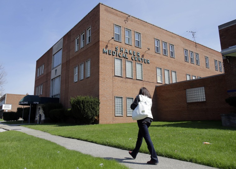 FILE - In this file photo taken April 28, 2015, a woman walks past the Center for Women's Health in Cleveland. When abortion-rights activists and newspaper editorialists in Ohio urged Republican Gov. John Kasich to veto abortion restrictions added to a state budget bill in 2013, most didn?t know his office helped draft some of the provisions. (AP Photo/Tony Dejak, File)