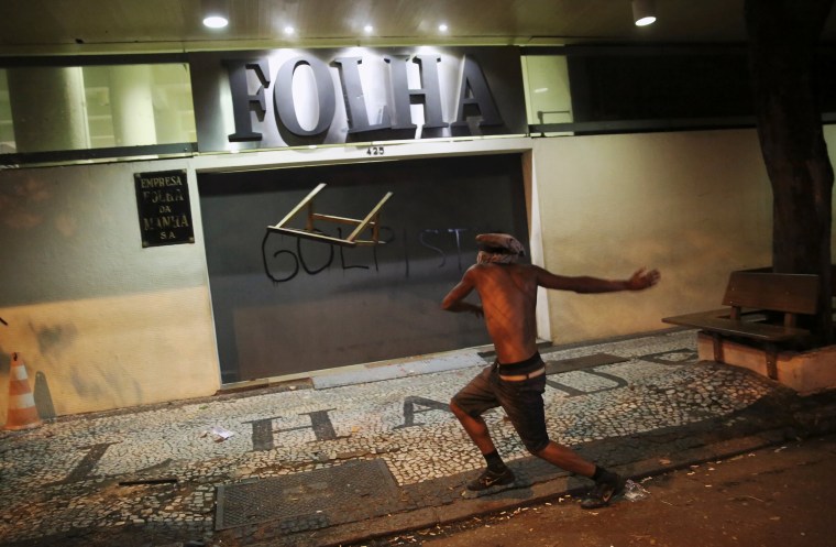 Image: A demonstrator attacks the Folha de S. Paulo newspaper office during a protest against Brazil's new President Michel Temer after Brazil's Senate removed former President Dilma Rousseff in Sao Paulo
