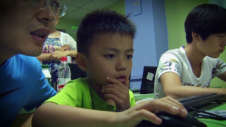 A young boy learns to code at the Tarena Learning Center in Beijing.