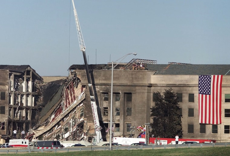 Image: USA FLAG HANGS AT IMPACT AREA ONE DAY AFTER HIJACKED JET CRASHED INTO PENTAGON