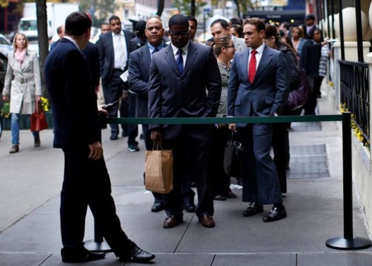 Job seekers stand in line to meet prospective employers at a career fair in New York City