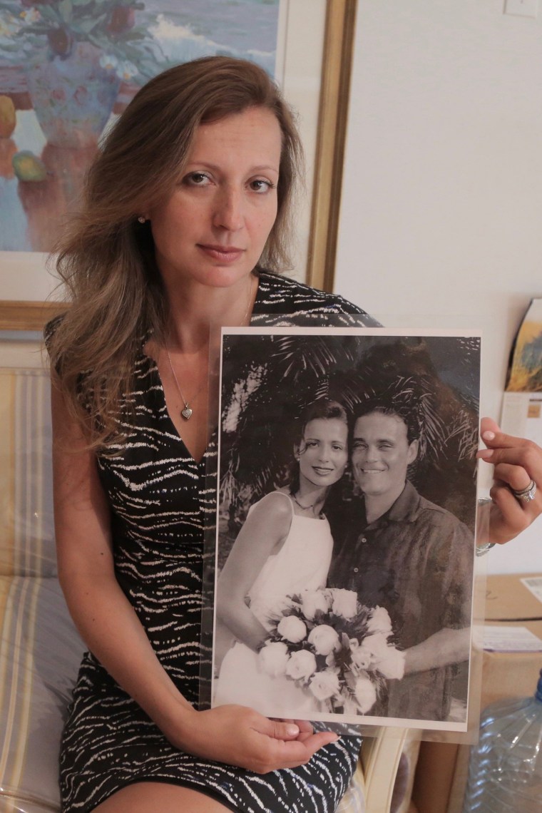 Image: Monica Iken-Murphy, whose husband Michael Iken died on 9/11, holds a photo from their wedding day in 2000, on Sept. 1, 2016 in New York.