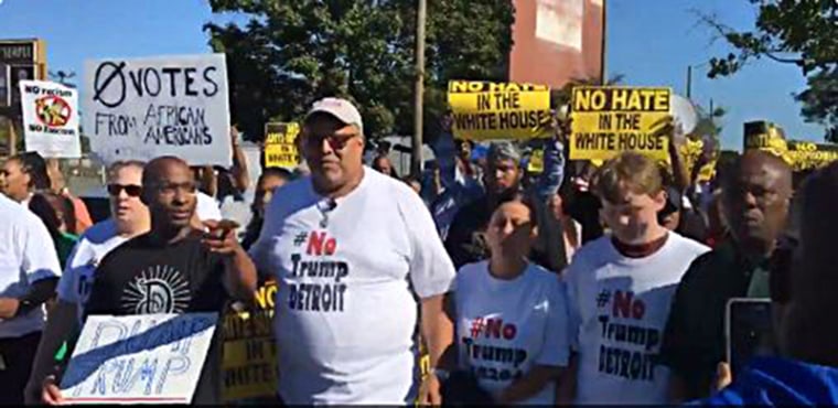 Protesters march ahead of Donald Trump's appearance in Detroit.