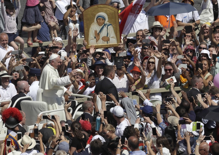 Image: Pope Francis passes in front of a portrait of Mother Teresa