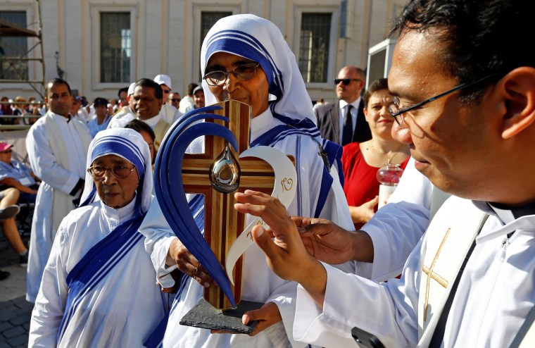 Image: A nun, belonging to the global Missionaries of Charity, carries a relic of Mother Teresa of Calcutta before a mass celebrated by Pope Francis for her canonisation in Saint Peter's Square at the Vatican