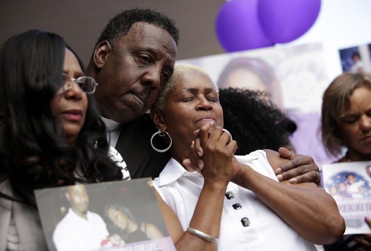 Image: The mother of Nykea Aldridge is embraced during a vigil for her daughter