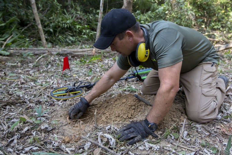 Image: A U.S. Marine searches for UXO near the village of Ban Na Ngom, Savannakhet, Laos