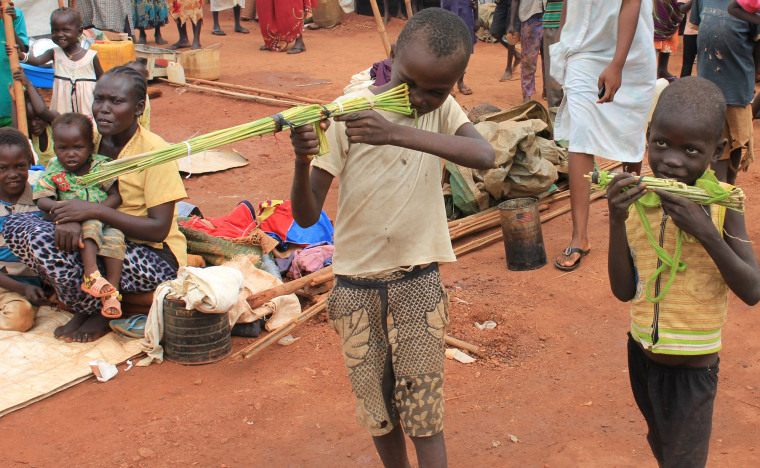 Image: Martin Andrea and a friend play with toy guns made from long grass reeds at a displaced persons camp protected by U.N. peacekeepers in Wau, South Sudan