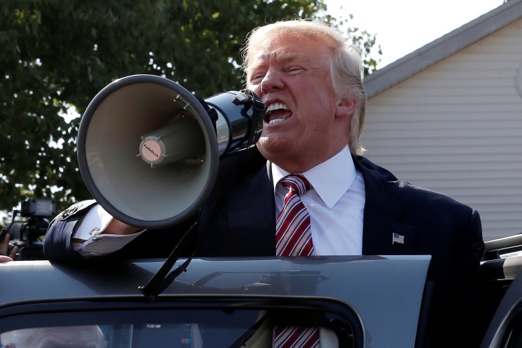 Image: Republican presidential nominee Donald Trump speaks to supporters through a bullhorn during a campaign stop at the Canfield County Fair in Canfield