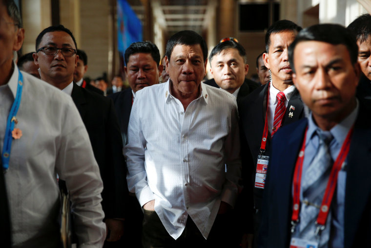 Image: Philippines President Rodrigo Duterte walks between meetings at the ASEAN Summit in Vientiane