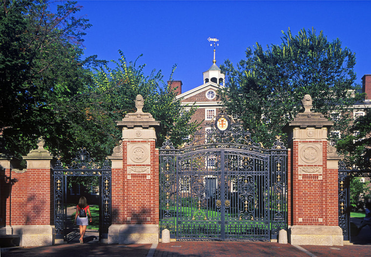 Student enters front gate to Brown University