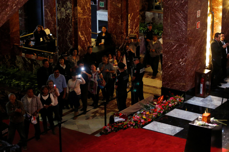 Image: Fans take pictures of the urn containing the ashes of Juan Gabriel during his second day homage in the Bellas Artes Palace in Mexico City