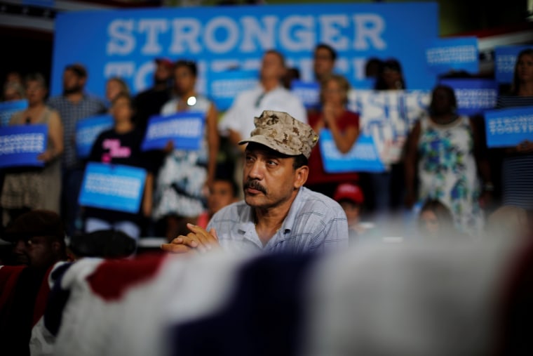 Image: Former Marine Kenny la Cruz listens as U.S. Democratic presidential nominee Hillary Clinton speaks at a campaign Voter Registration Rally at the University of South Florida in Tampa