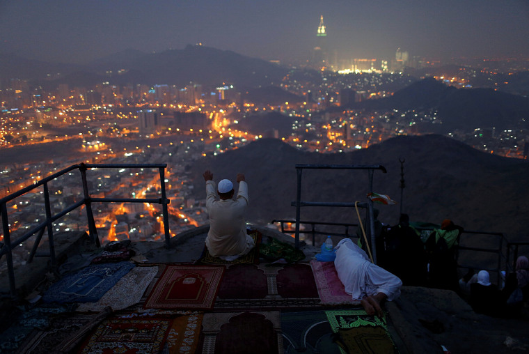 Image: A pilgrim prays at Mount Al-Noor ahead of the annual haj pilgrimage in the holy city of Mecca