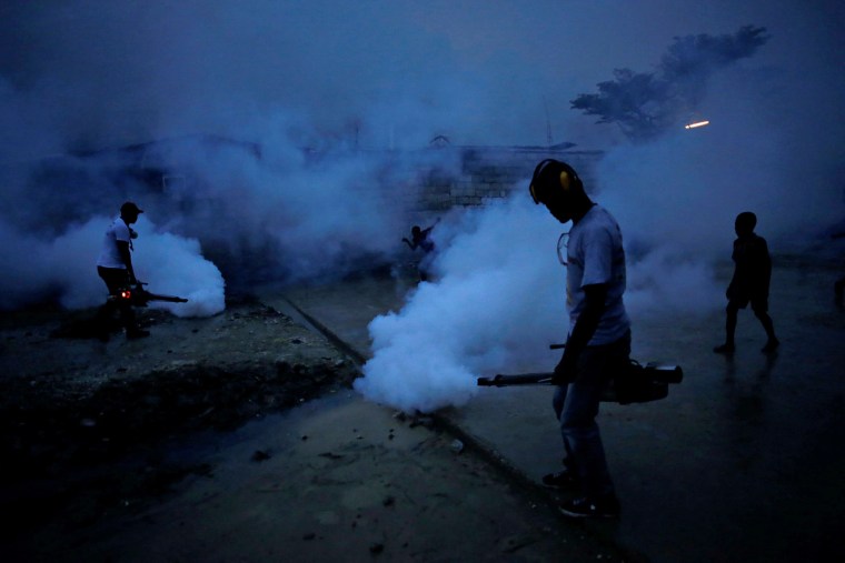 Image: Workers of the Ministry of Public Health and Population fumigate in the street against mosquito breeding to prevent diseases such as malaria, dengue and Zika, during a fumigation campaign in Port-au-Prince, Haiti