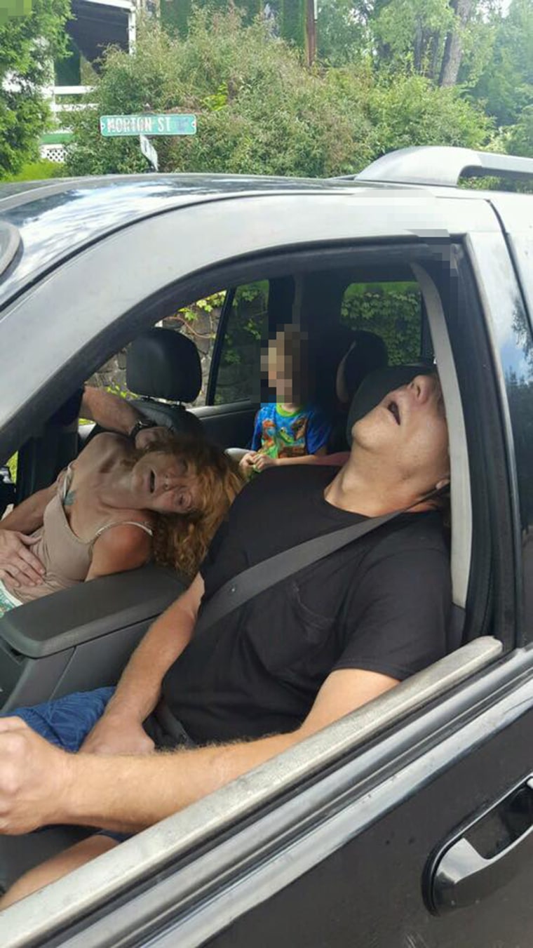 East Liverpool Police Department posted a photograph on the departments Facebook page of a couple overdosing on heroin in an SUV while a 4-year-old looks on from the back seat.