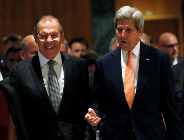 Image: U.S. Secretary of State Kerry and Russian Foreign Minister Lavrov walk into their meeting room in Geneva
