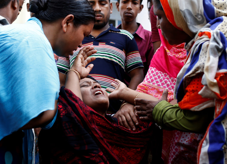 Image: A woman mourns at a hospital after a fire broke out at a packaging factory outside Dhaka
