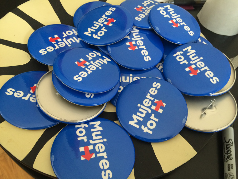 A bowlful of Mujeres for Hillary button are part of a campaign to get Latinas to turn out other Latinas to vote.