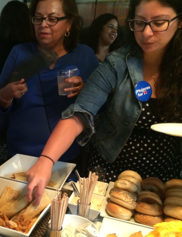 Latinas supporting Hillary Clinton reach for tamales set out for Latinas at a brunch organized by Hillary Clinton supporters held Sept. 10, 2016 in the Washington, D.C. neighborhood of Adams Morgan.
