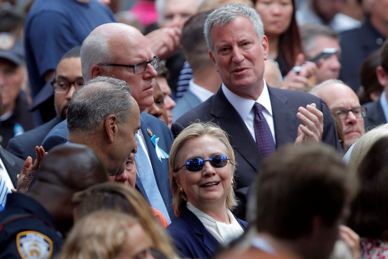 Image: U.S. Democratic presidential candidate Hillary Clinton and New York Mayor Bill de Blasio attend ceremonies to mark the 15th anniversary of the September 11 attacks at the National 9/11 Memorial in New York